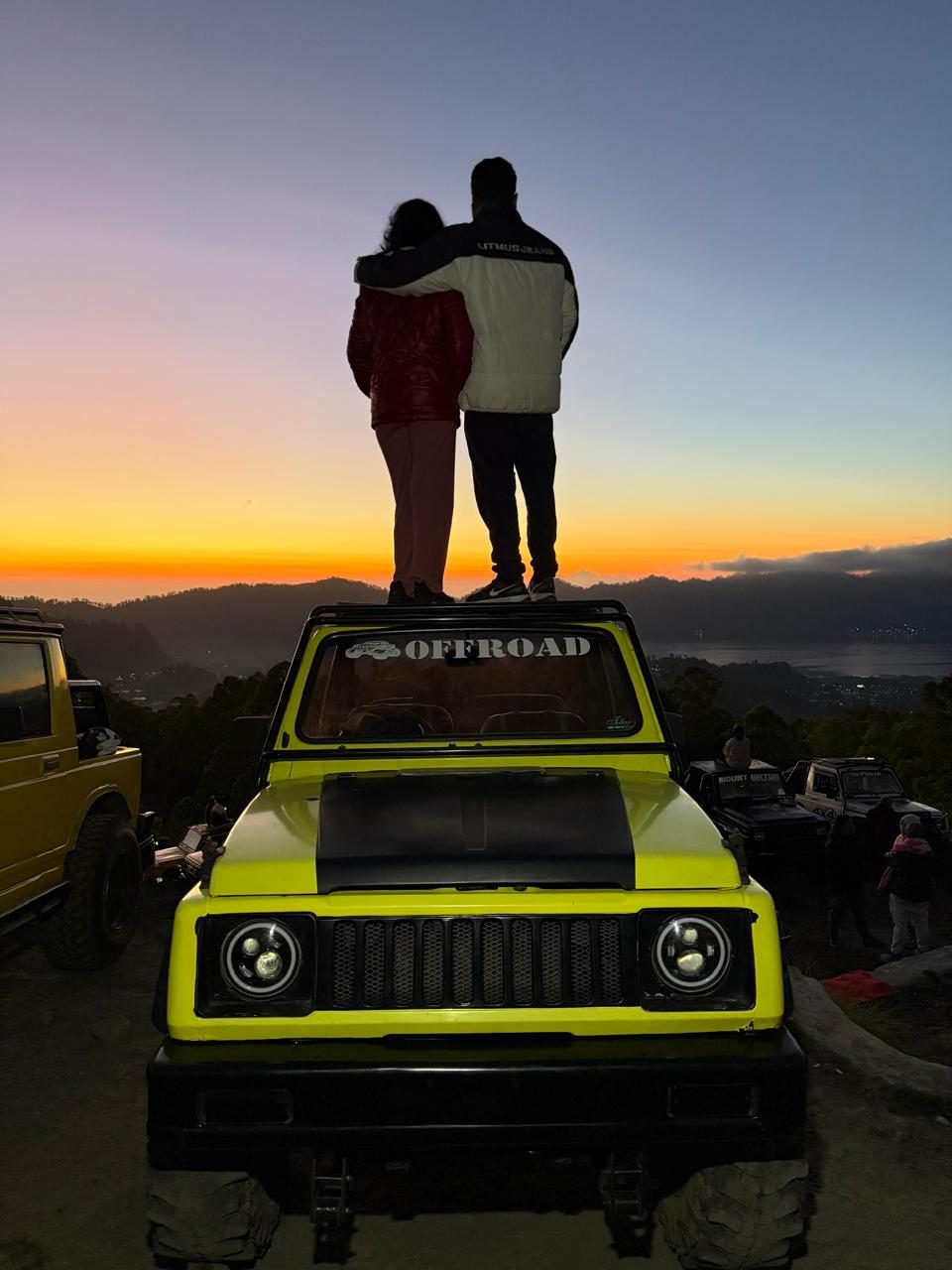 Watching the sunrise together on top of an offroad jeep