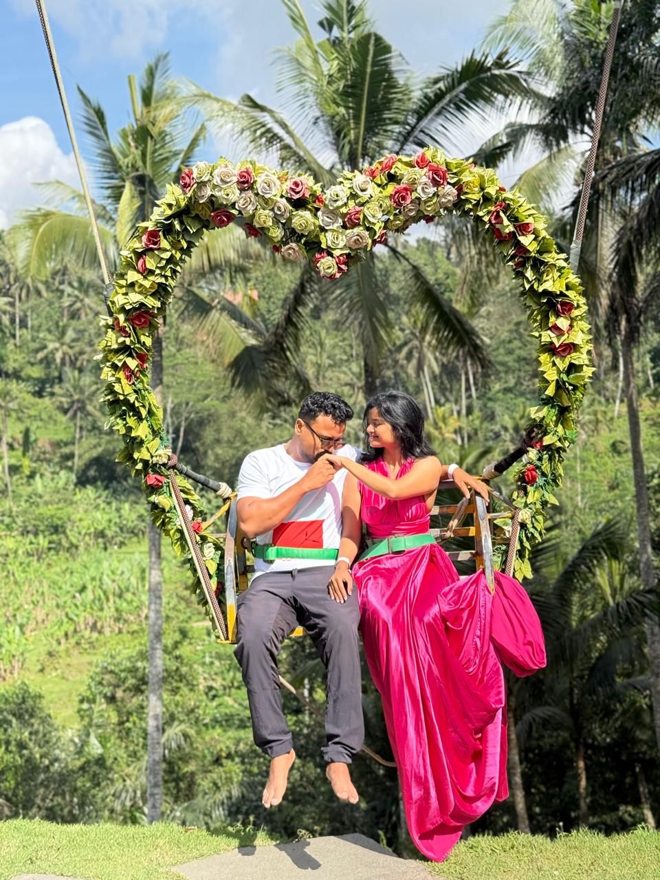 On a flower swing among palm trees